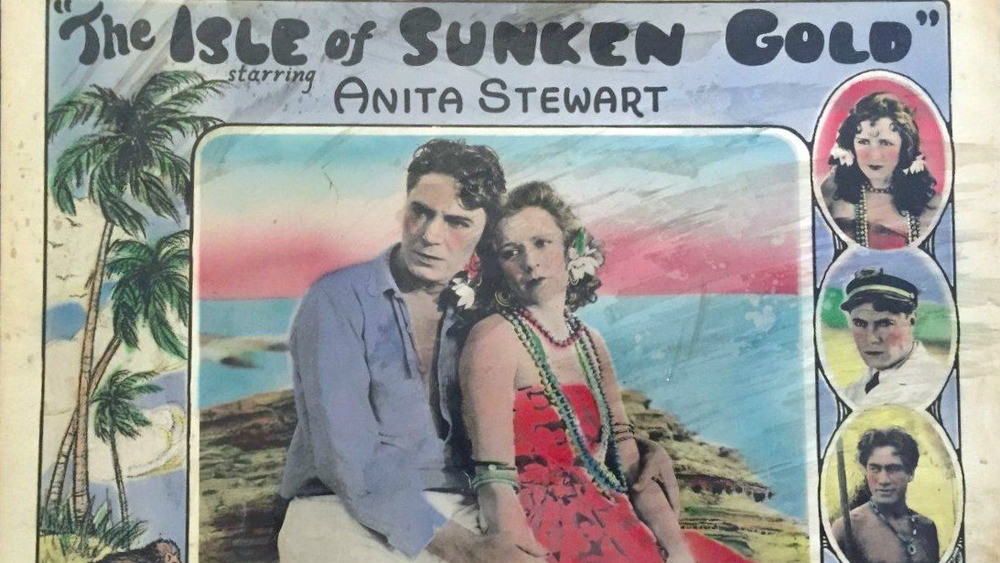Lobby card for the American film serial Isle of Sunken Gold (1927) with Bruce Gordon, Anita Stewart, and Duke Kahanamoku