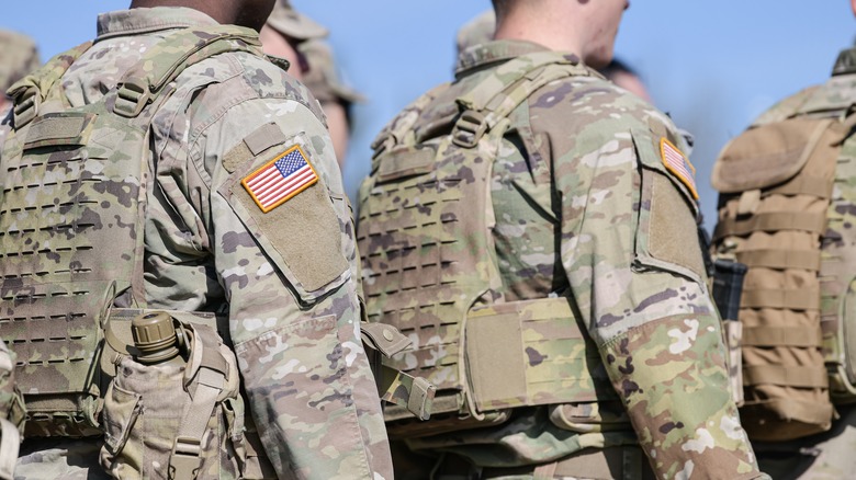 backs of men army camo uniform