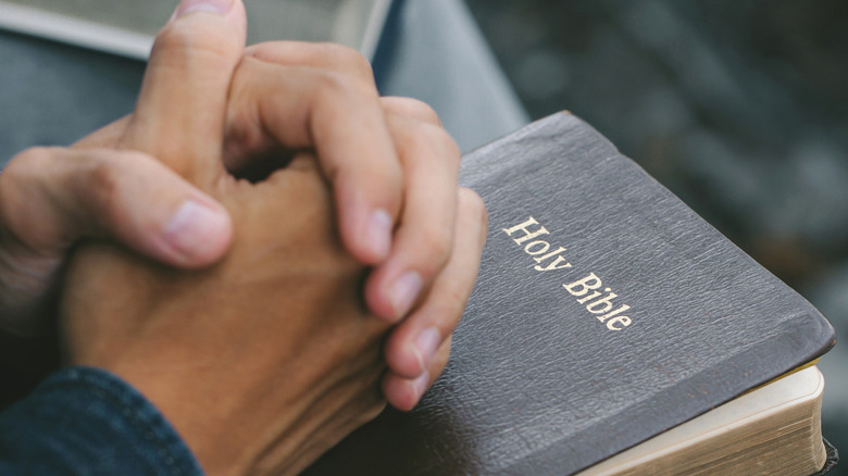 bible and praying hands