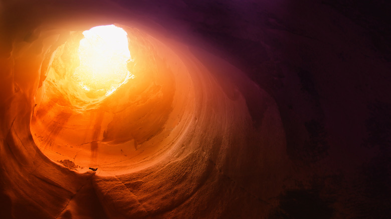 Dramatic sunlit cave entrance (tomb)