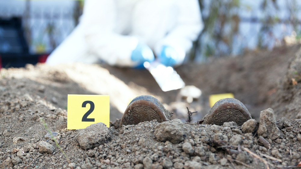 Police exhume a body from the ground