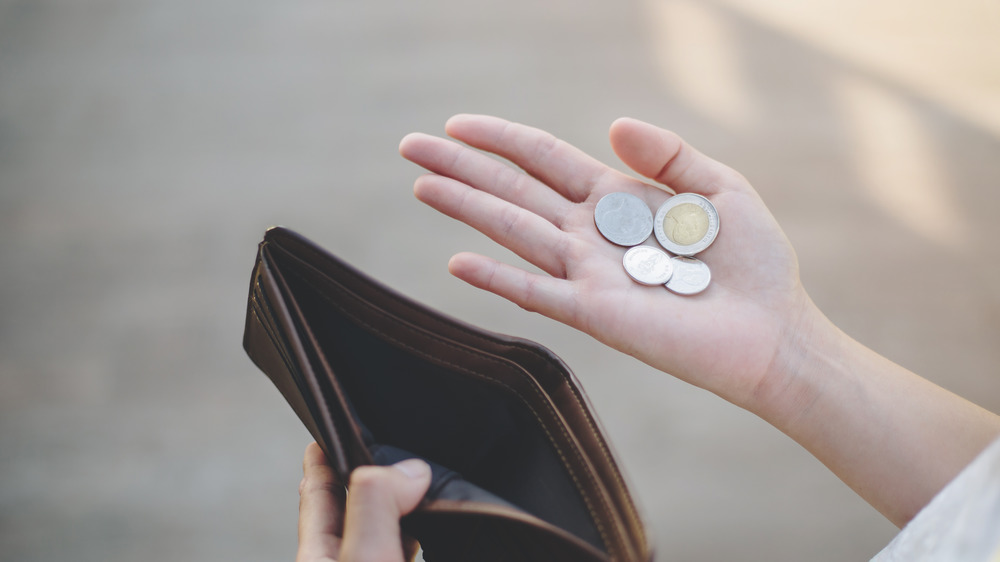 Broke person holding change