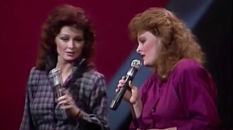Naomi and Wynonna Judd holding microphones