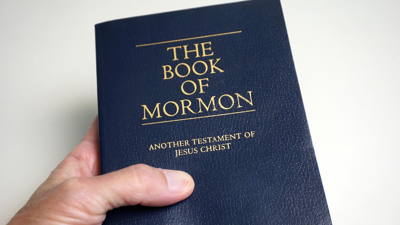 Hand holding The Book of Mormon
