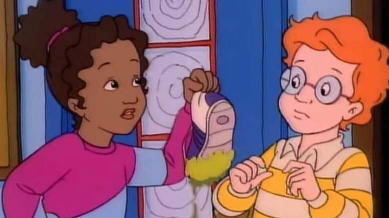 Keesha Franklin showing a dirty sneaker to Arnold Perlstein in The Magic School Bus