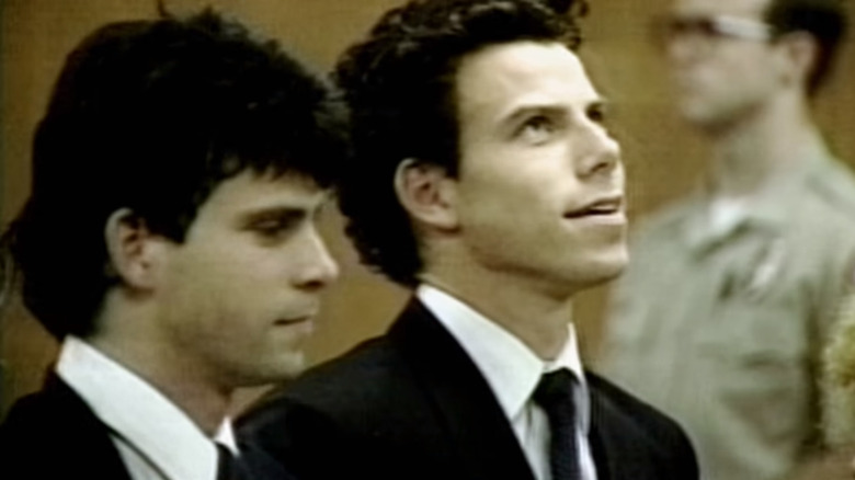 Erik and Lyle Menendez sitting in courtroom smiling