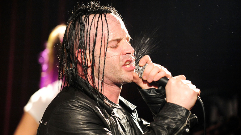 A dreadlocked Michale Graves singing on stage