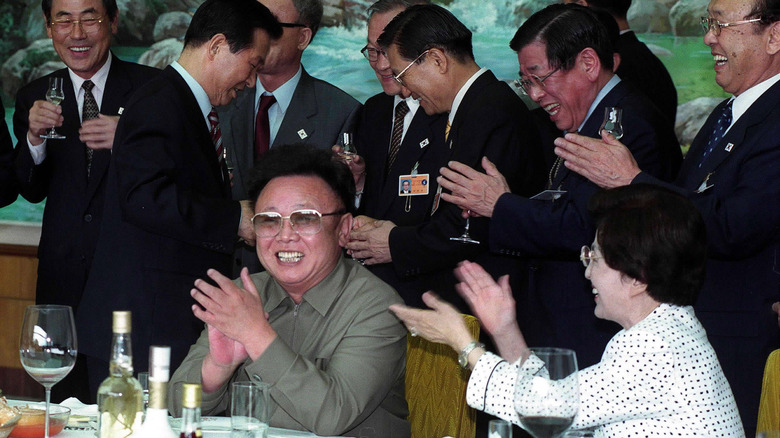 Kim Jong-il laughing with politicians