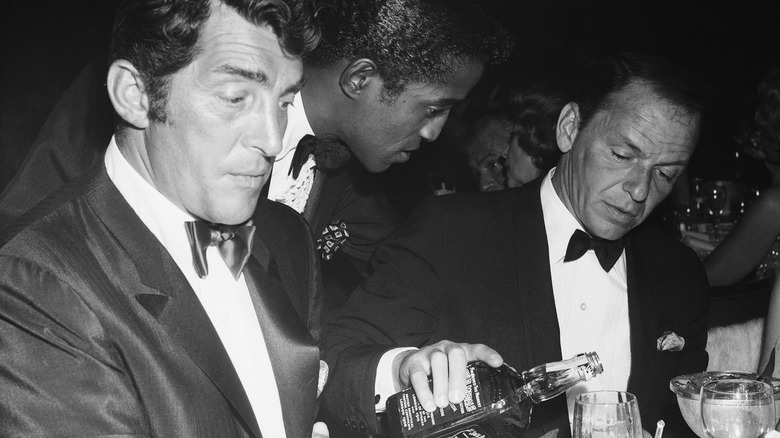 Dean Martin, Sammy Davis Jr., and Frank Sinatra all looking down