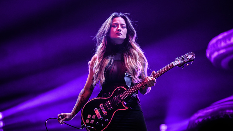 Kiki Wong playing guitar on stage