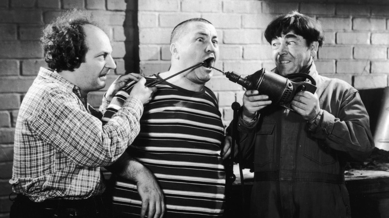 The Three Stooges perform some amateur dentistry.