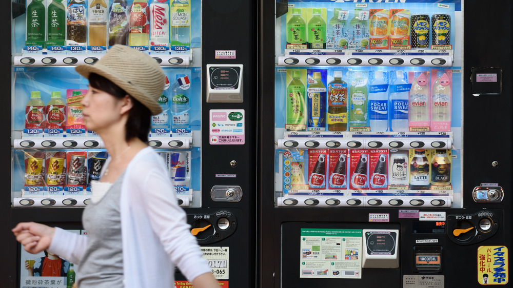 Woman strolling past vending machines