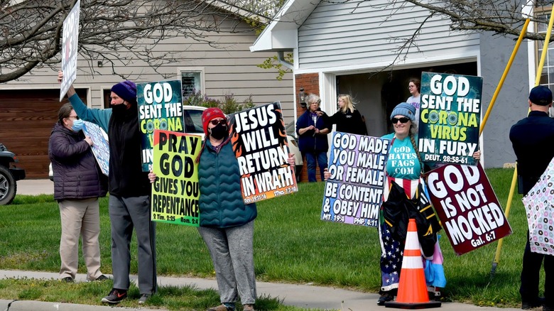 Church members holding protest signs