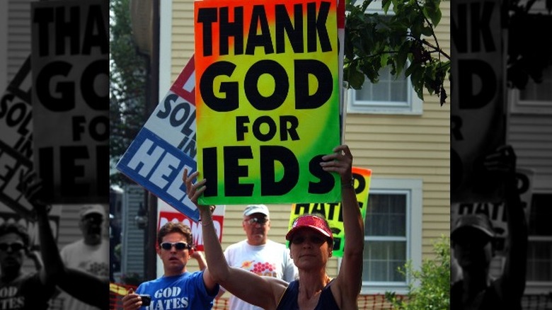 Church members holding protest signs