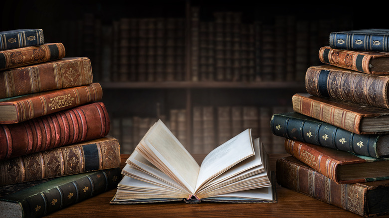 open book between stacks of other books