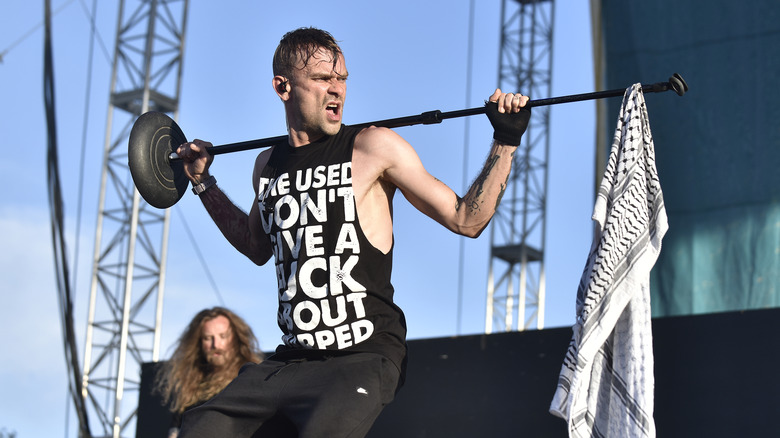 Bert McCracken holding a mic stand