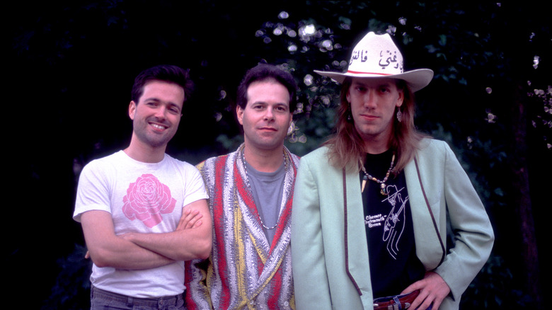 Violent Femmes standing together outside smiling