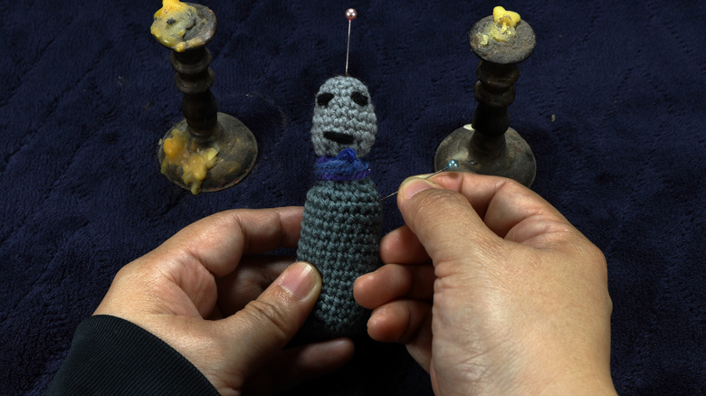 hands making a voodoo doll