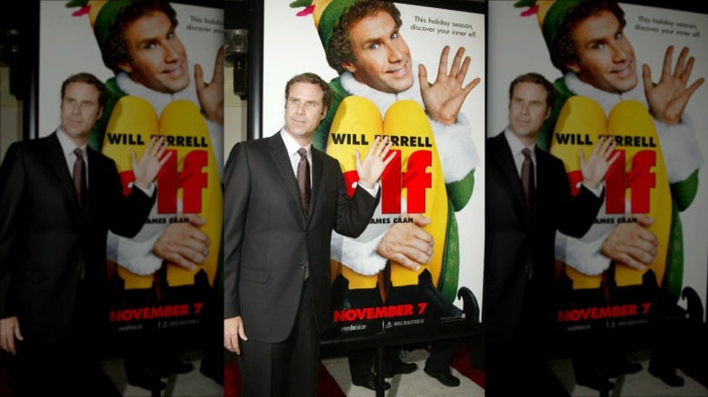 Will Ferrell posing with Elf poster