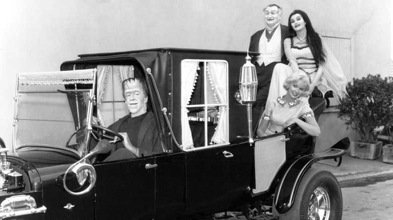 Munsters cast posing in ccar