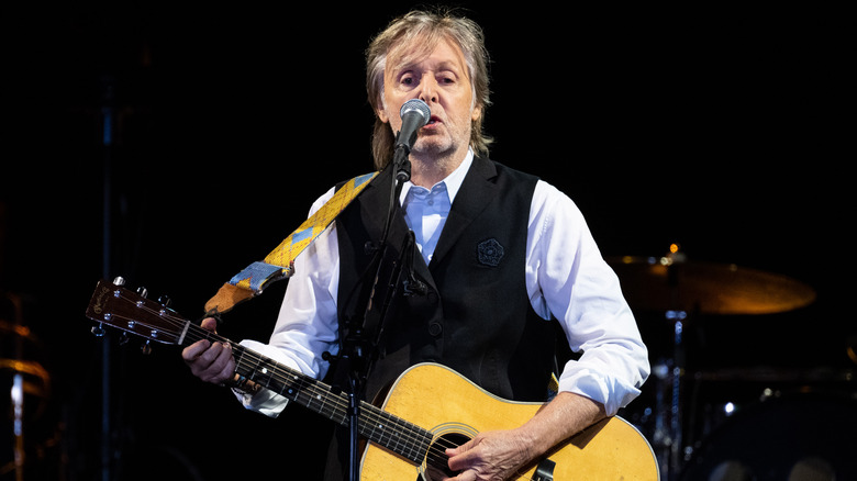 Paul McCartney performing on stage