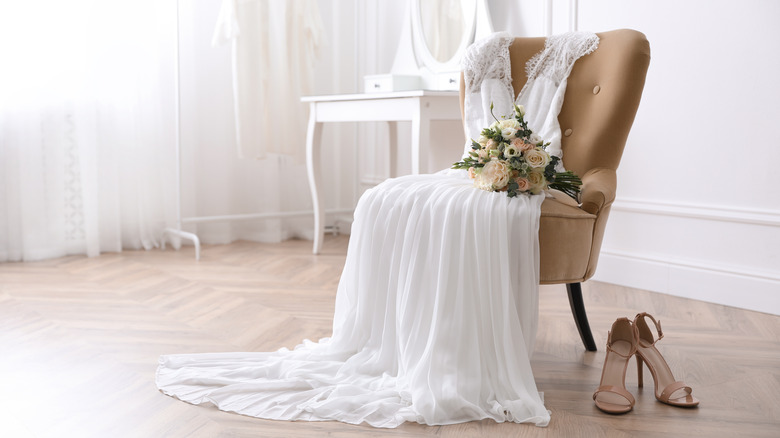 wedding dress draped on a chair