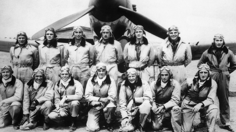 flying tiger pilots pose with plane