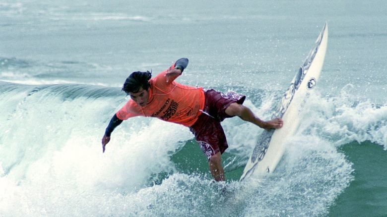 Mikala Jones surfing