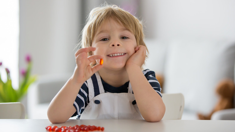 A toddler with a carrot