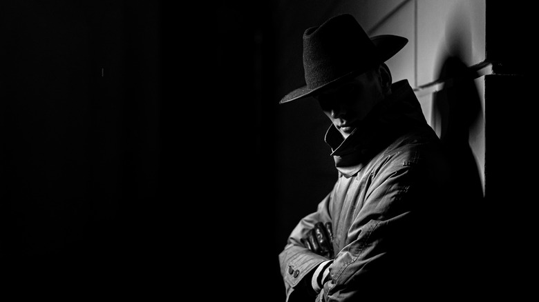 man in shadows leaning