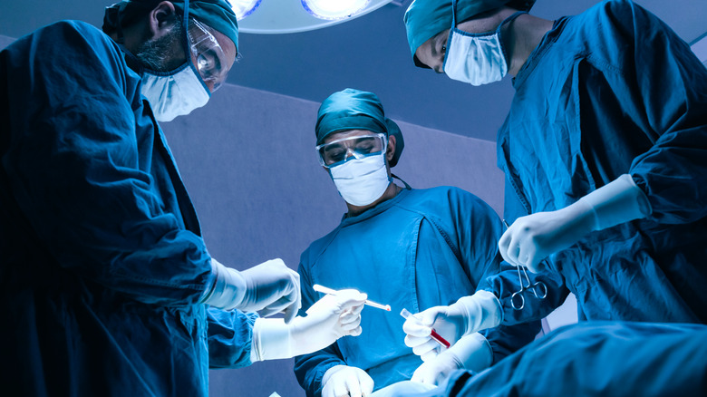 Doctors removing tumor
