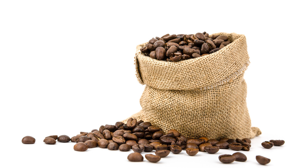 Bag of coffee beans spilling on the ground