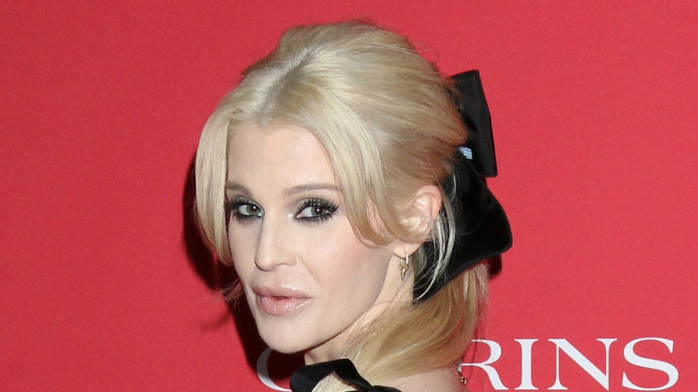 Kelly Osbourne staring ahead