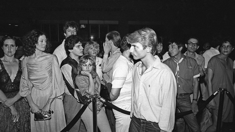 Studio 54 doorman Mark Benecke selects entrants from a waiting crowd, 1979