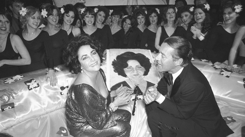 Elizabeth Taylor and fashion designer Halston in front of her birthday cake, Studio 54.
