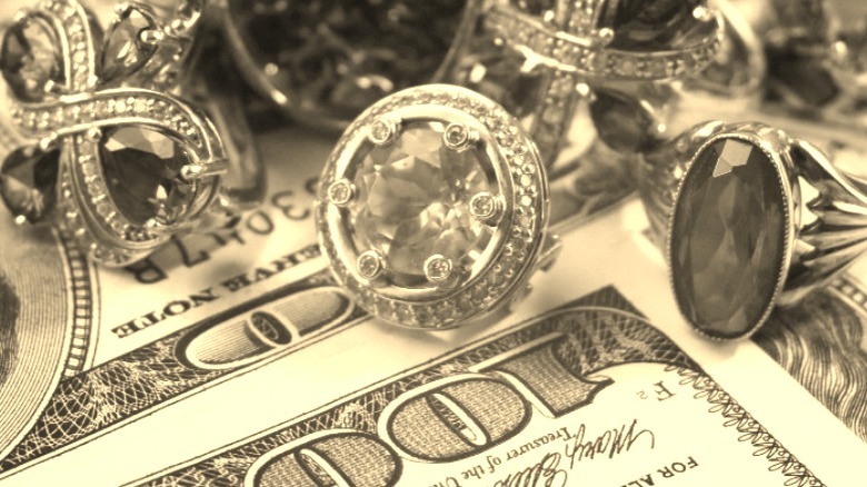 100 dollar bills and jewelry