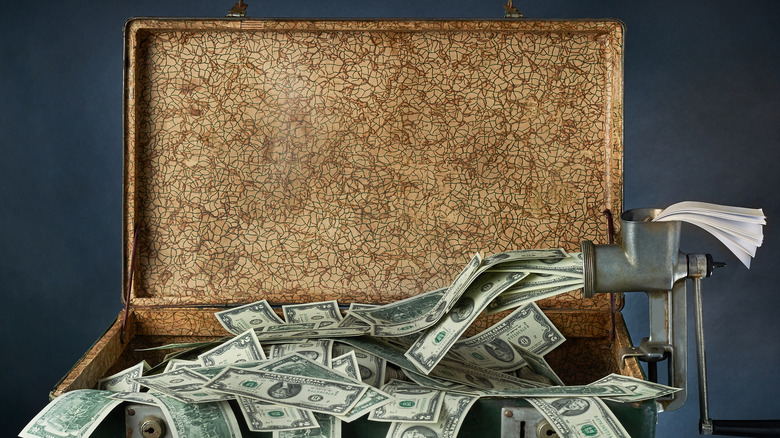 Suitcase filling with money