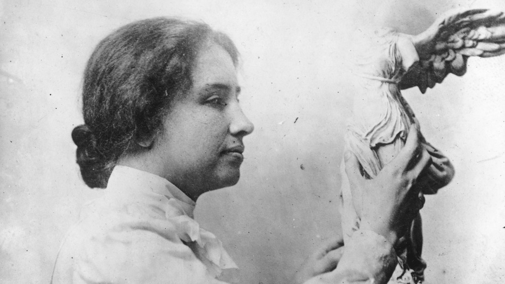 Helen Keller holding statue