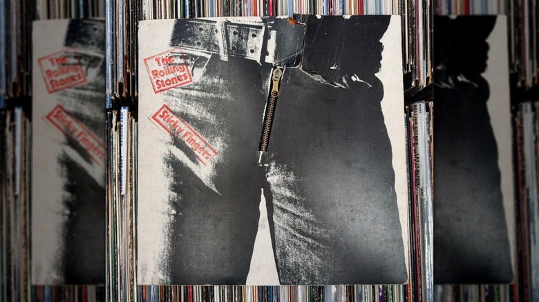 The Rolling Stones' "Sticky Fingers" LP with zipper, sitting on top of other records