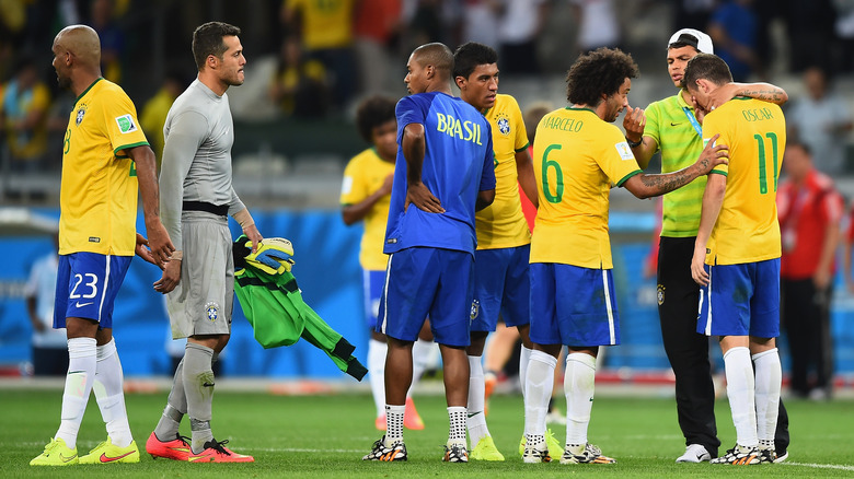 Brazil players console each other after 7-1 loss at the World Cup
