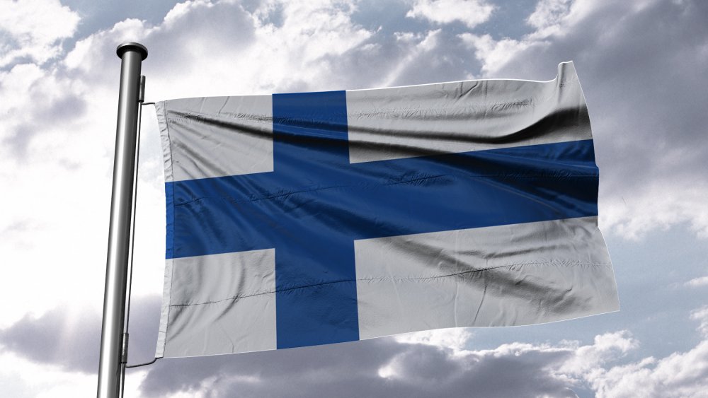 The Finnish flag flaps in the breeze of a blue sky