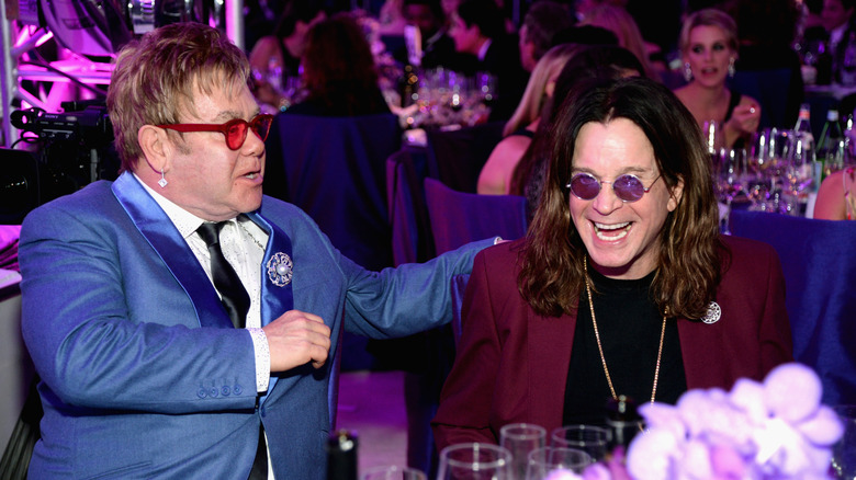 Elton John putting hand on shoulder of laughing Ozzy Osbourne