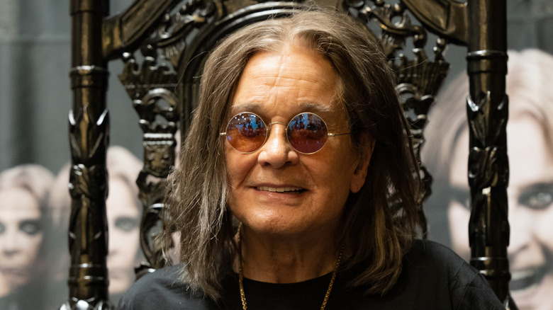 Ozzy Osbourne smiling in throne chair