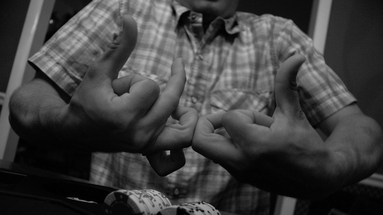 Man forming Bloods gang sign