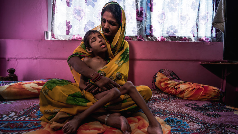 Bhopal victims sitting on floor
