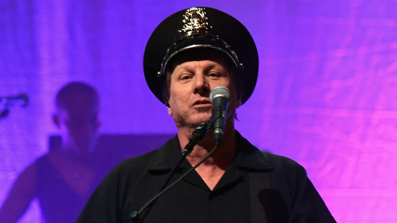 Adrian Belew in police hat onstage at 2017 David Bowie tribute