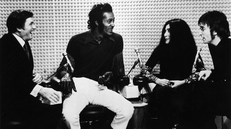 Mike Douglas, Chuck Berry, Yoko Ono, and John Lennon seated together on The Mike Douglas Show