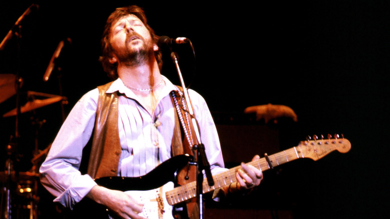 Eric Clapton playing guitar in 1976