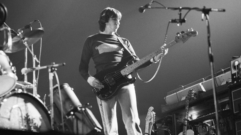 Pink Floyd's Roger Waters playing bass guitar on stage in 1977