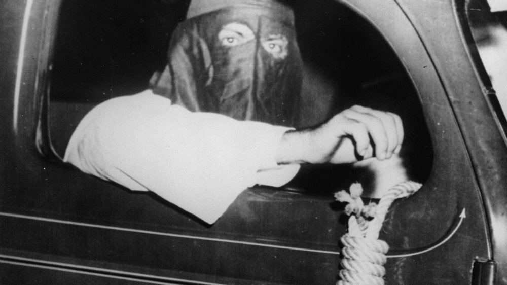 CIRCA 1939: Member of the Ku Klux Klan with a noose, 75 cars of the Ku Klux Klan were driving through Miami, Florida to hold off black people frrm the election